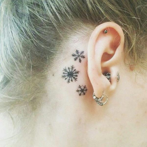 Snowflakes tattoo behind ear