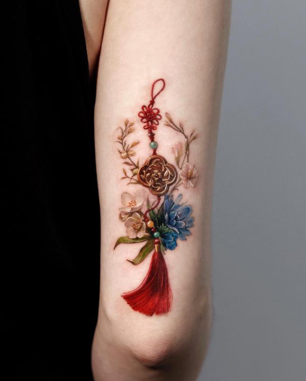 Tassel with flowers tricep tattoo