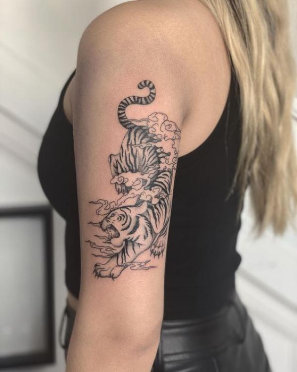 Tiger in clouds tricep tattoo