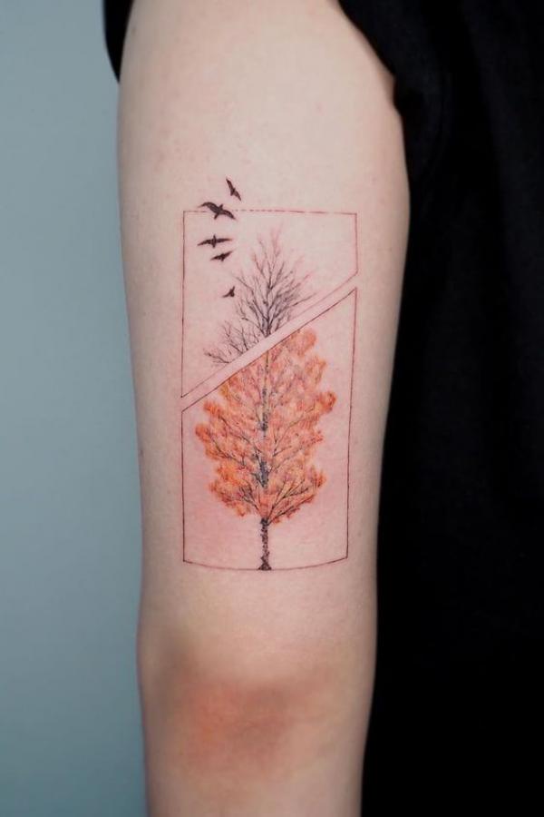 Tree with birds tricep tattoo