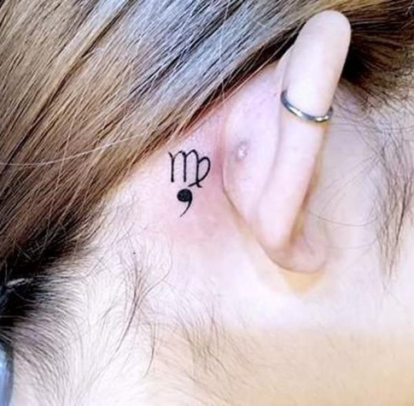 Virgo glyph and semicolon tattoo behind ear