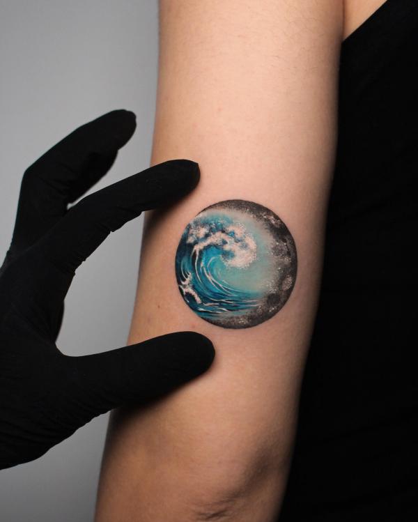 Wave and moon tricep tattoo