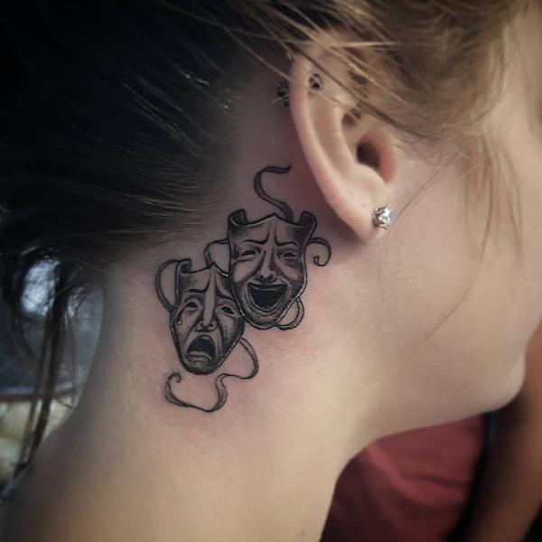 laugh now cry later masks tattoo behind ear