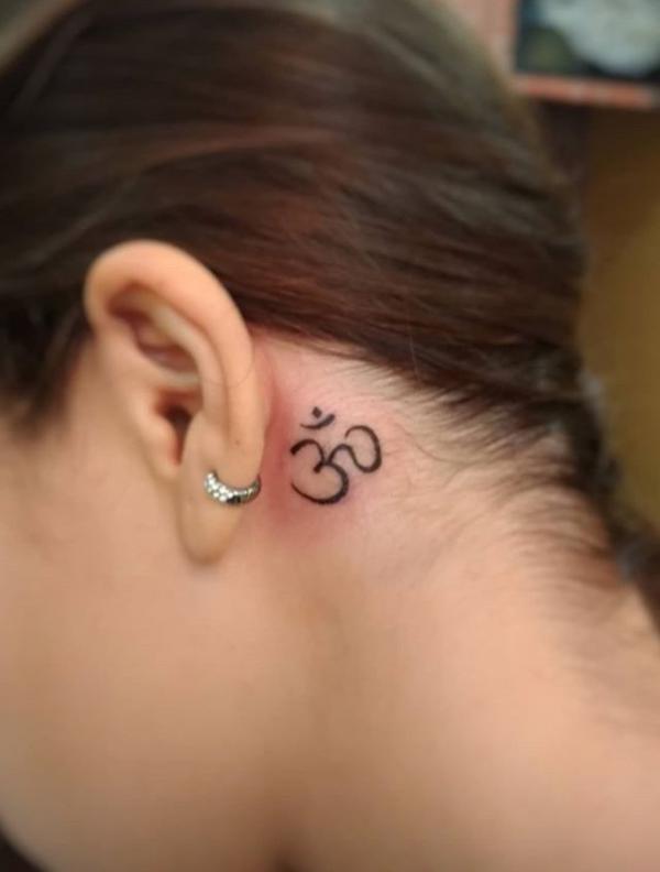 om tattoo behind the ear